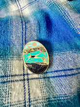 Cornish seapool wild swimming enamel pin badge on a checked shirt
